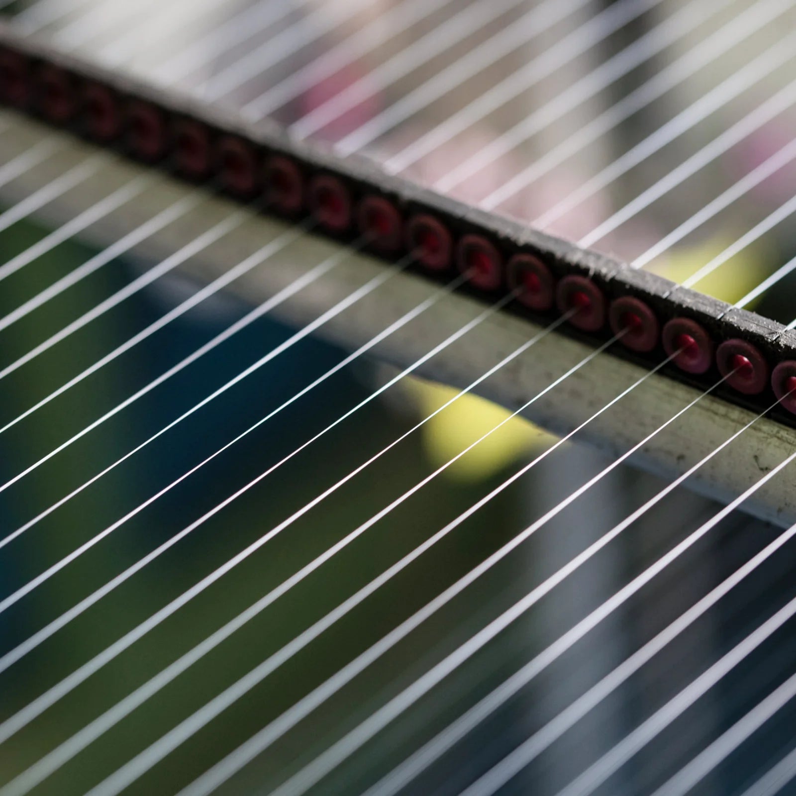 Nahaufnahme von Webfäden in einer Textilmaschine, die den nachhaltigen Produktionsprozess von MYMARINI zeigt.