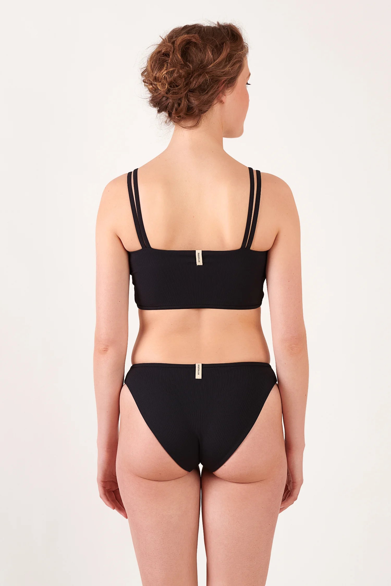 Schwarzes Bikinitop mit breiten Trägern und passende Bikinihose von MYMARINI, sichtbar von hinten.#color_black