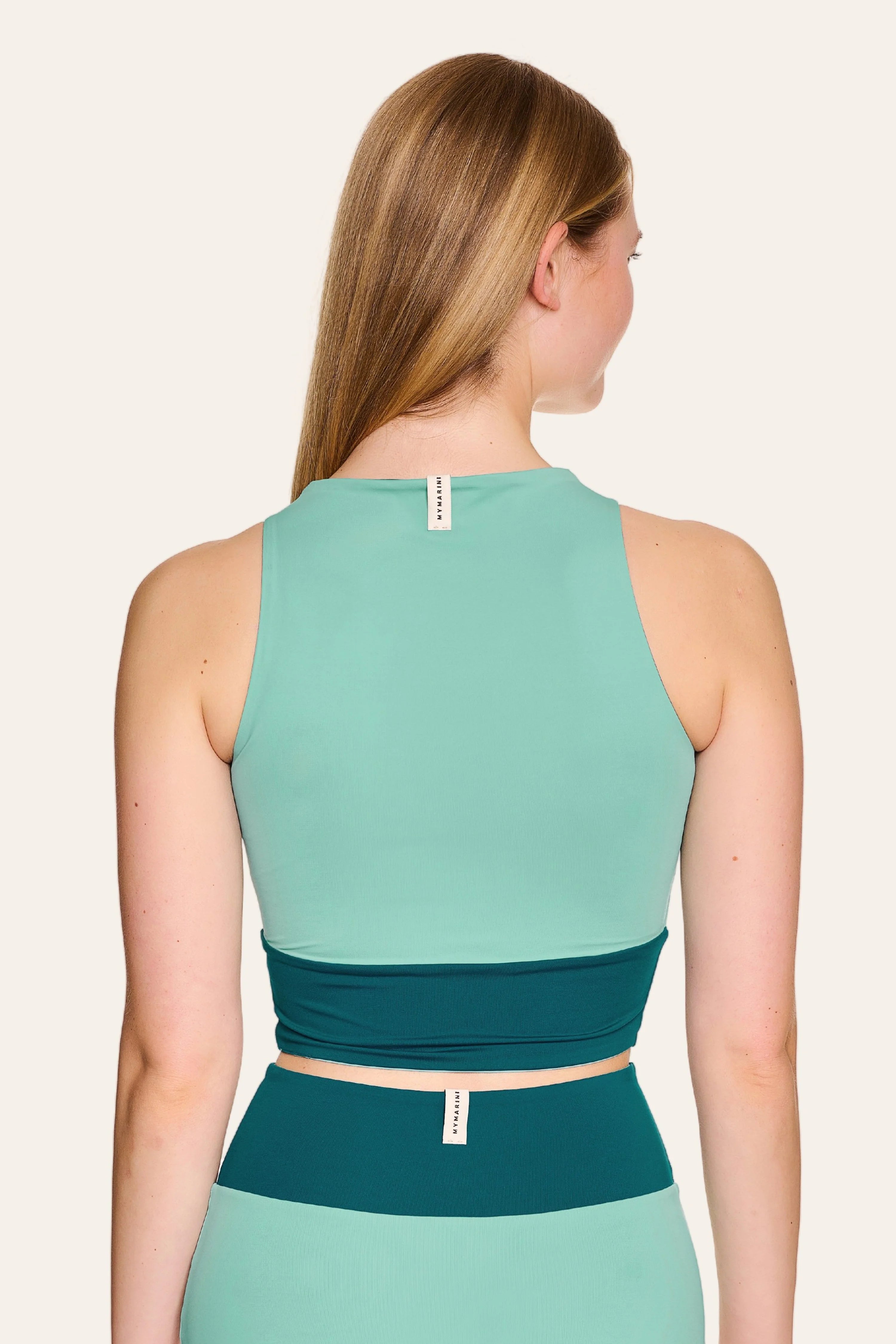 Frau in MYMARINI Bikinitop mit breiten Trägern und passender Bikinihose, Rückansicht, in Türkis- und Petroltönen.#color_eucalyptus-petrol