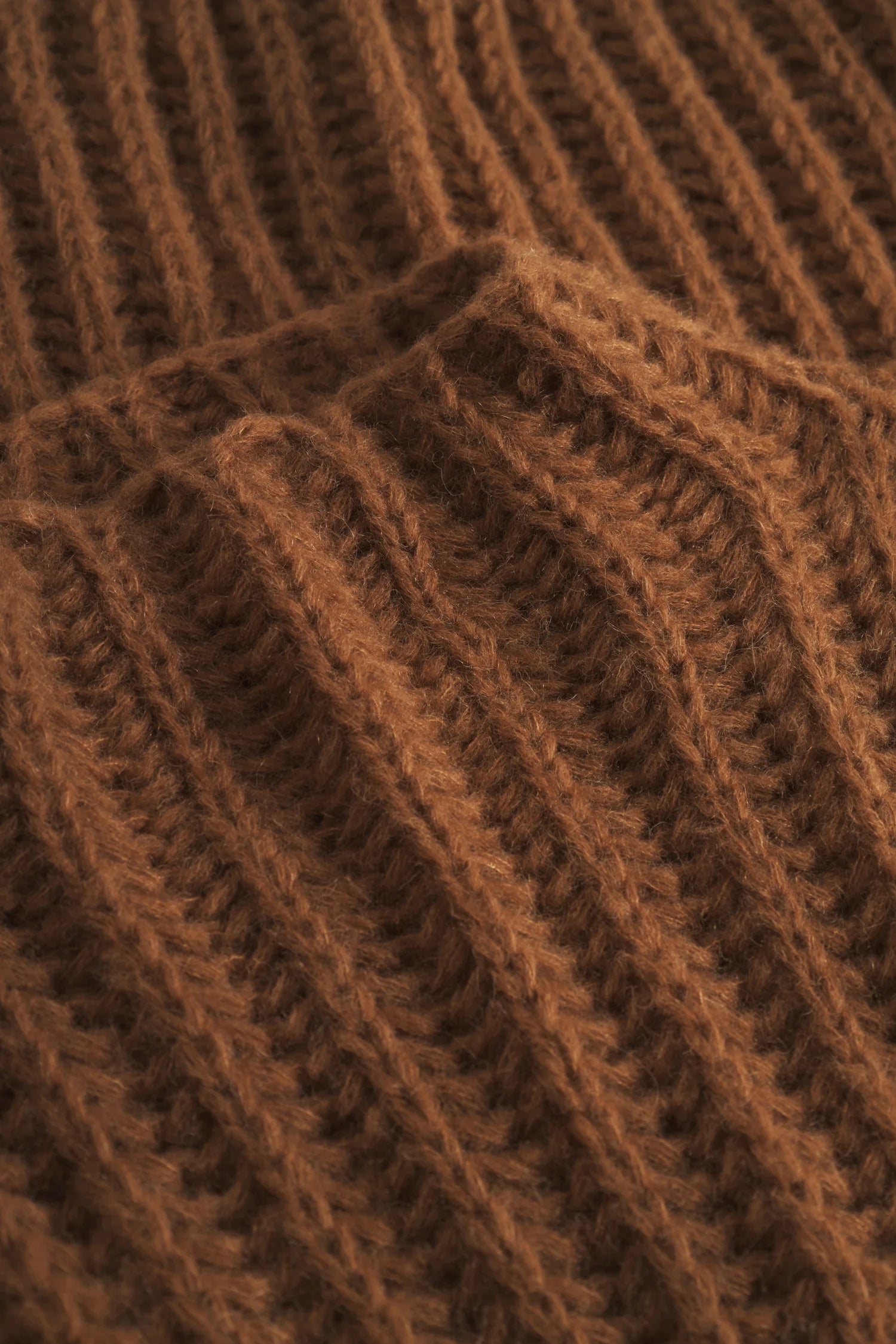 Strickstoff in Brauntönen mit Rippenmuster, Detailansicht.#color_camel