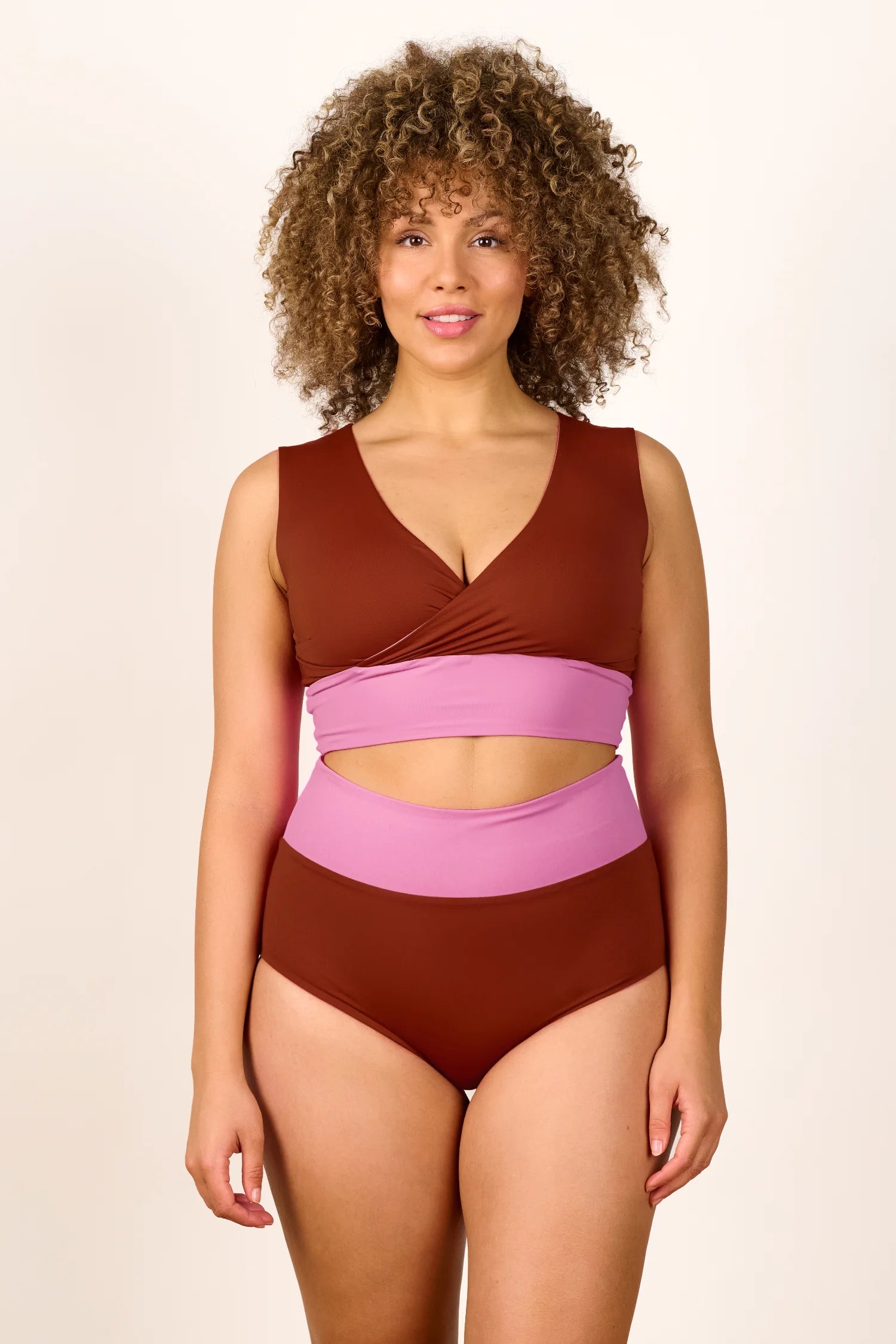 Person trägt MYMARINI Bikini mit breiten Trägern und hohem Beinausschnitt in Braun und Rosa.#color_sienna-orchid