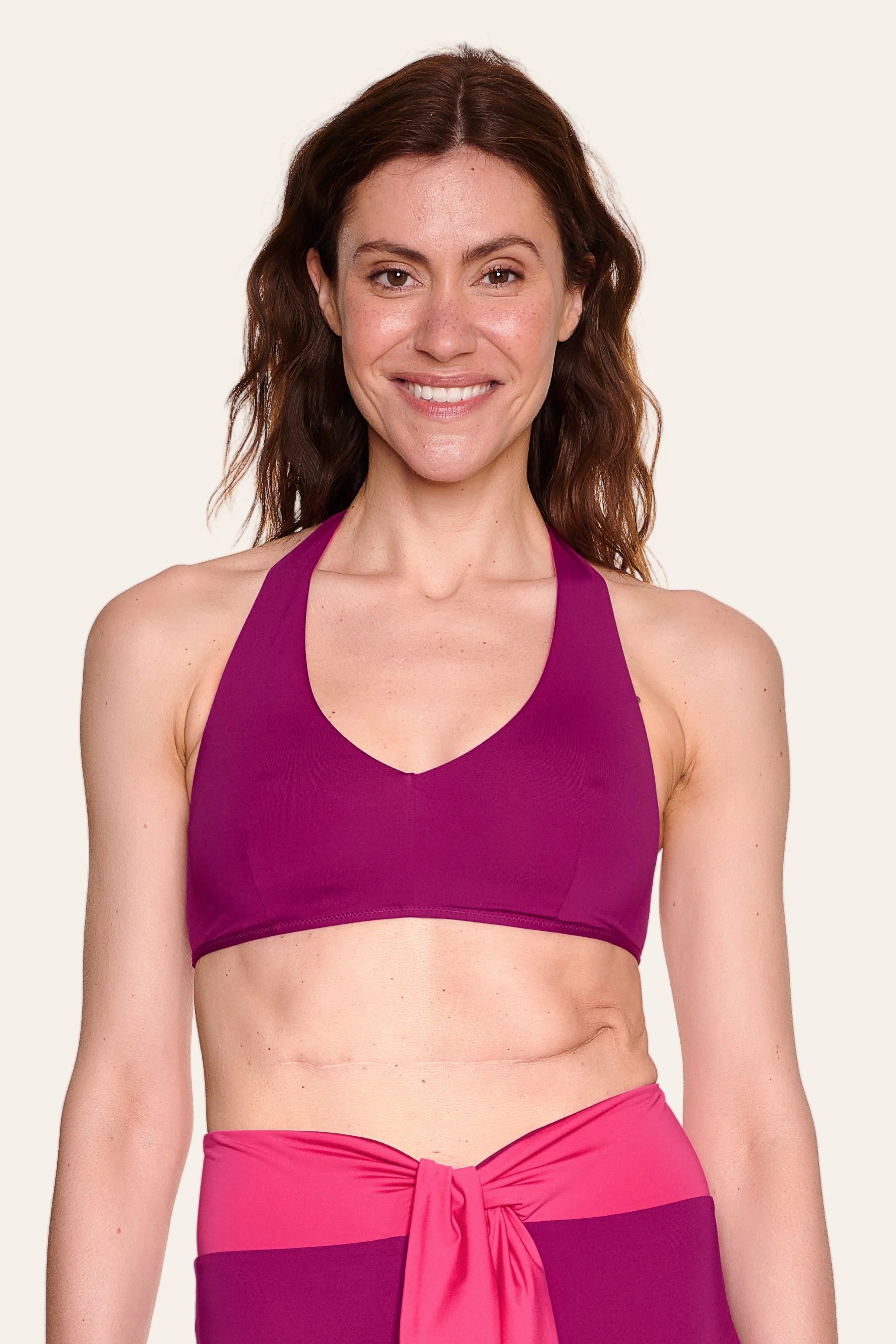 Frau trägt MYMARINI Bikinitop mit V-Ausschnitt und breiten Trägern in Lila.#color_pink-hortensia