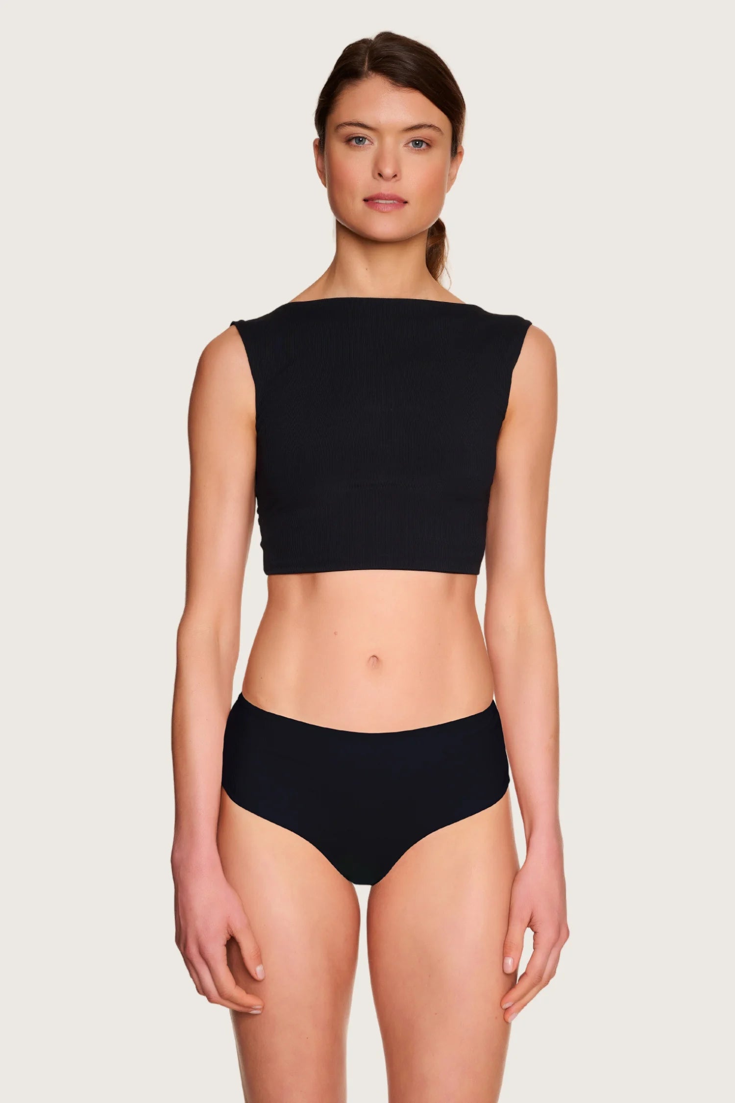 Person trägt schwarzes MYMARINI Bikinitop mit breiten Trägern und schwarze Bikinihose mit hohem Beinausschnitt.#color_black