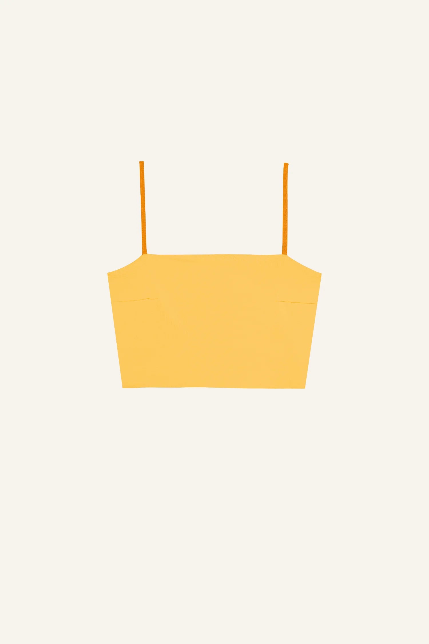 Gelbes Bikinitop von MYMARINI mit Spaghettiträgern vor weißem Hintergrund.#color_buttermilk-soleil