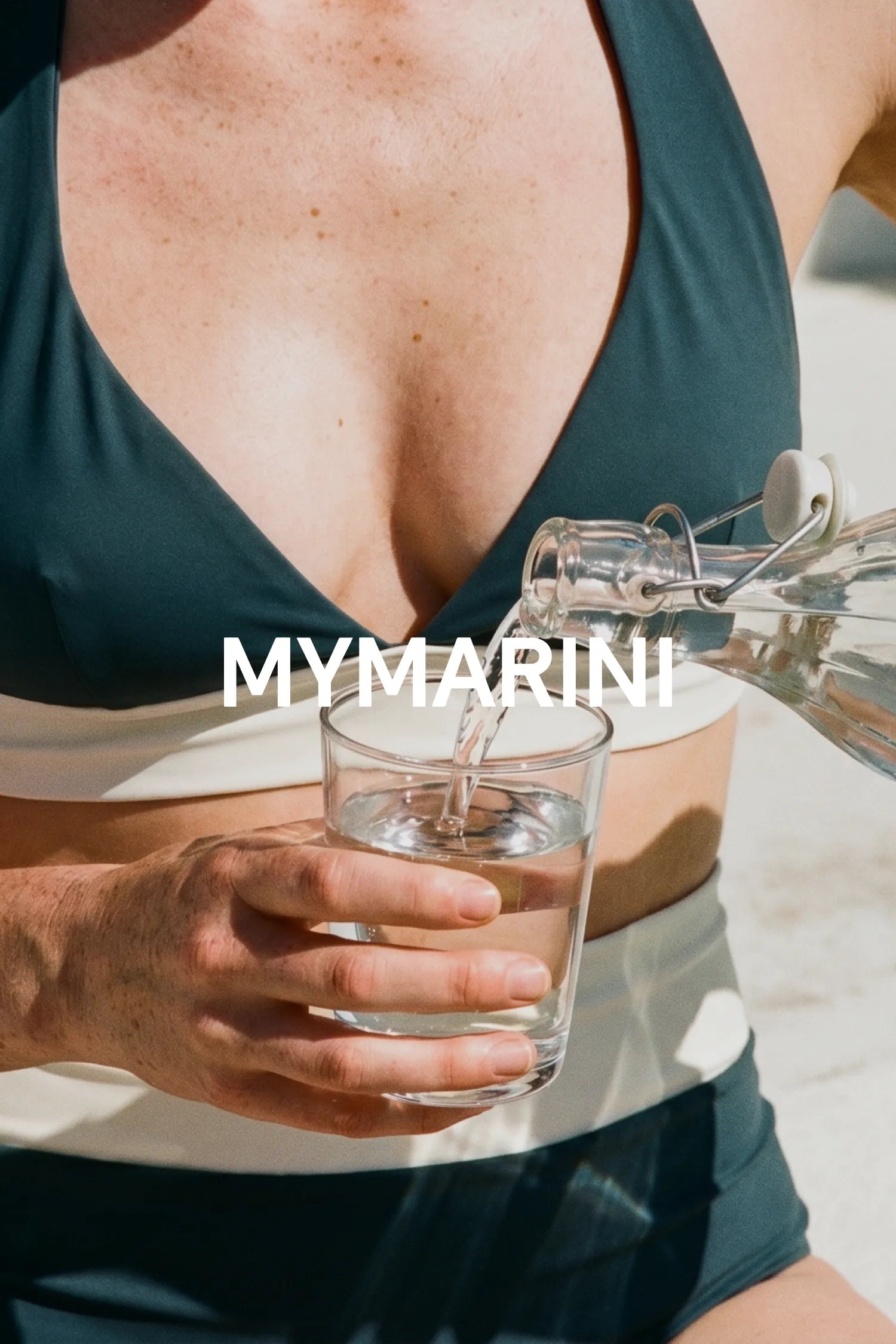 AI-generated, woman in petrol swimwear pouring water from a swing-top bottle into a glass, MYMARINI wordmark