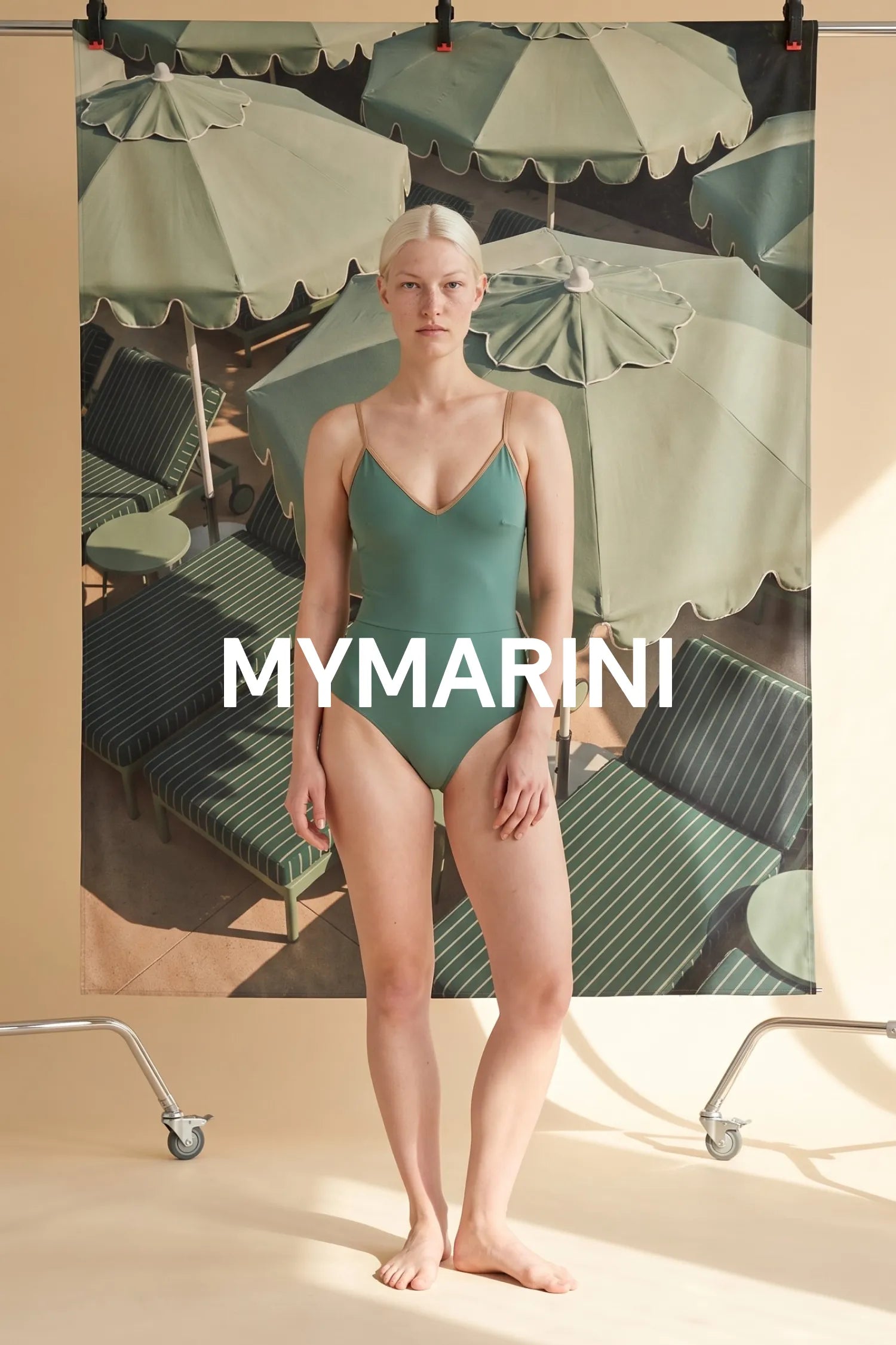 AI-generated, Model wearing the MYMARINI swimsuit with spaghetti straps in lagoon-teal by green parasols