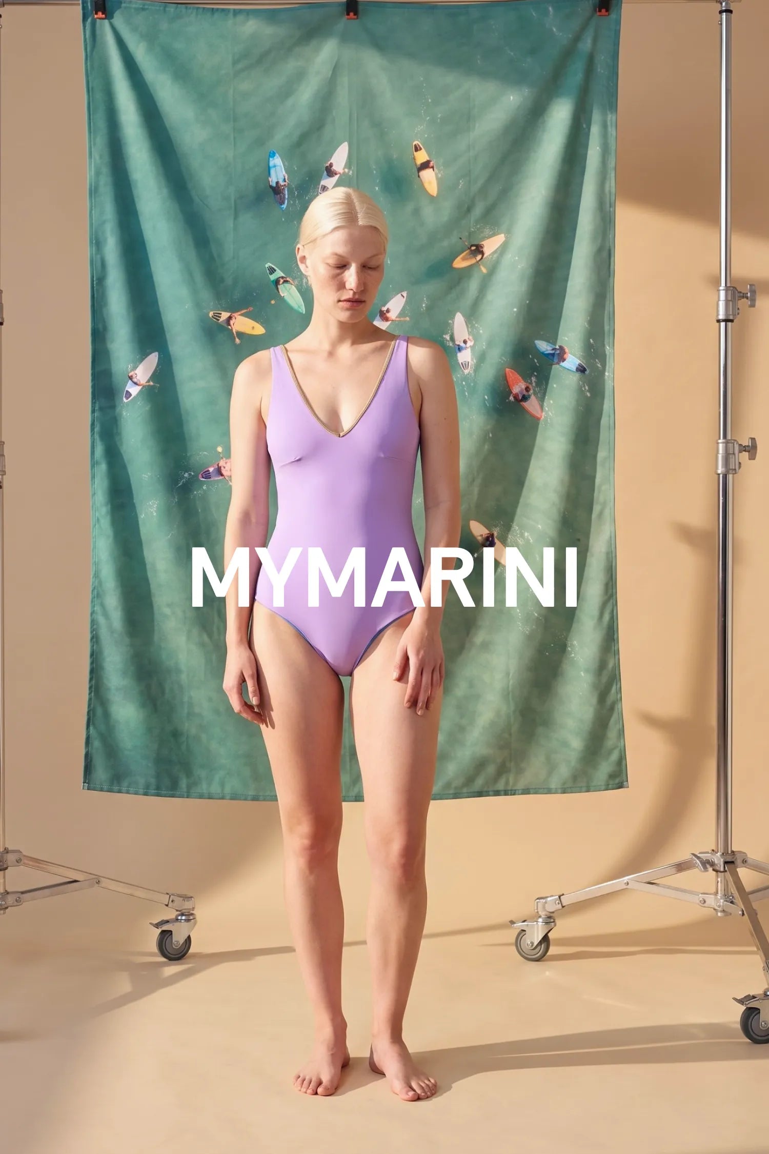 AI-generated, Model wearing the MYMARINI swimsuit with a V-neckline in lapis-lavender by water with surfers