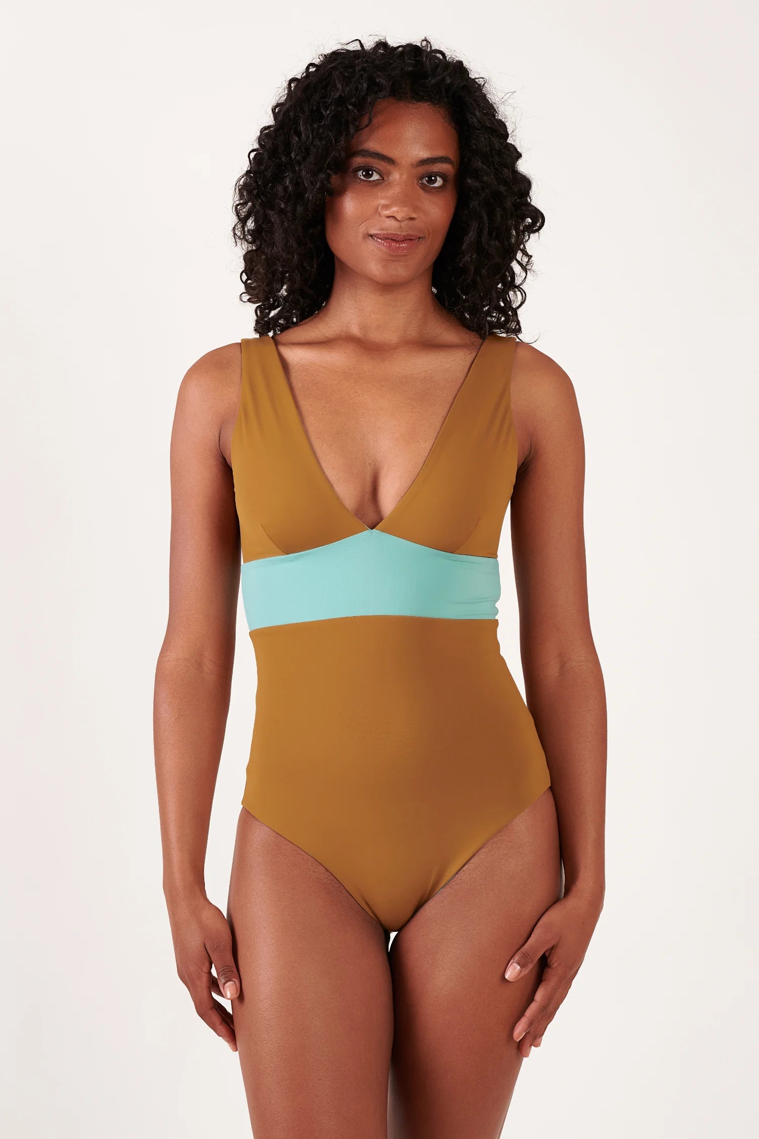 MYMARINI einteiliger Badeanzug in Braun mit Hellblau-Akzent, tiefer V-Ausschnitt, breite Träger, an einer Frau präsentiert.#color_oak-eucalyptus